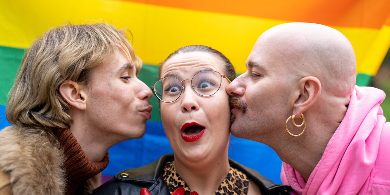 Pride celebration: three people laughing in the street